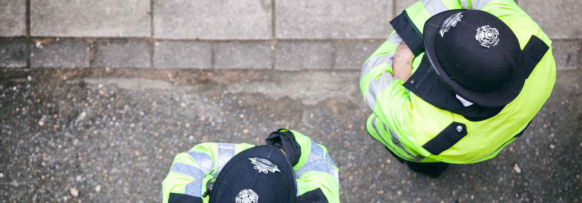 two police officers standing on the pavement