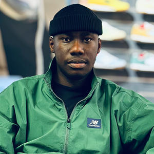 A male student smiling as he poses for a photograph.