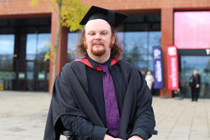 Cai Brown in his graduation cap and brown