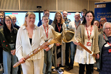 The students holding two prototypes of their mace designs