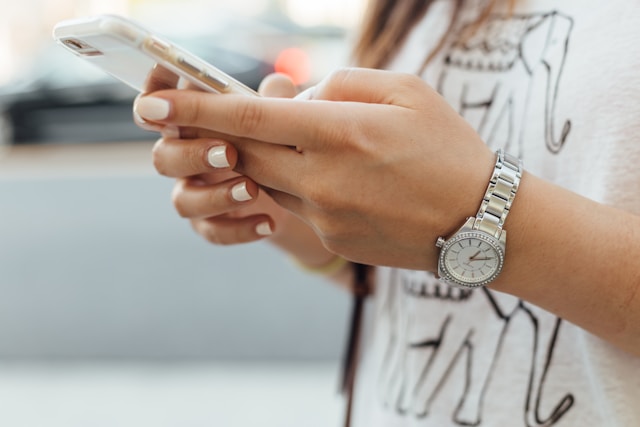 A close up of a woman's hands holding a mobile phone