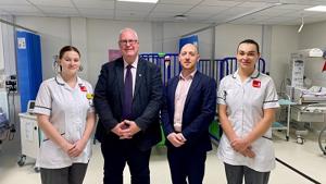 Four peoplestood in hospital ward setting