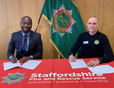 Dr Nana Agyeman and Chief Fire Officer Rob Barber signing the MOU