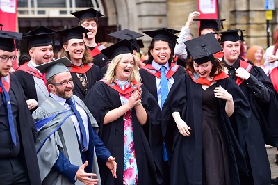 Group of students wearing cap and gown