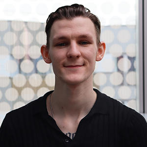 A male student posing for a photograph.