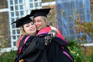 Female graduates hugging