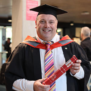 Marc Roberts in his graduation cap and gown