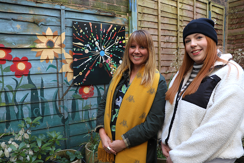 Claire Gwinnett and Laura Wilkinson next to one of the plastic artworks