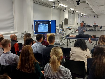 People sat watching a demonstration in the lab