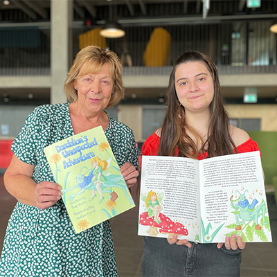 Sue Perks and Amber Bond holding copies of their book