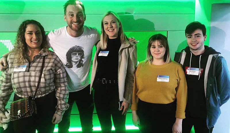 Students with Capital Radio host