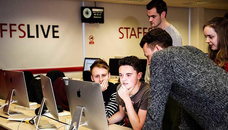 Students working around computer