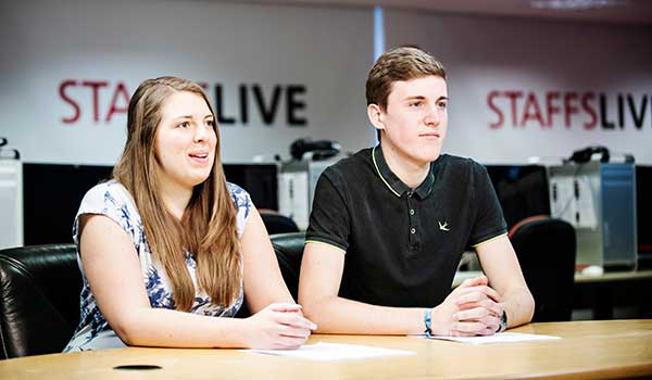 Students working through a script in the newsrooms