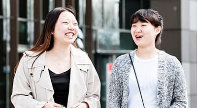 Two smiling students at Staffordshire University.