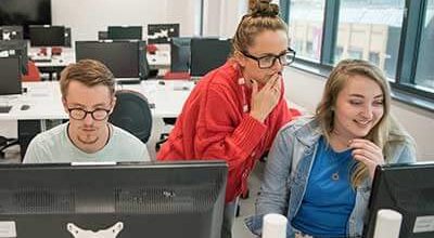 Students at computers looking up visa advice.