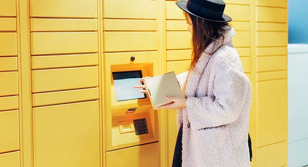 Woman using parcel locker service