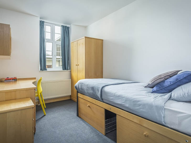 Bedroom in Poland house featuring single bed, desk and wardrobe